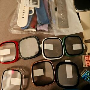 Fitbit Sense 2 with stand up charger, multiple bands and screen protectors.